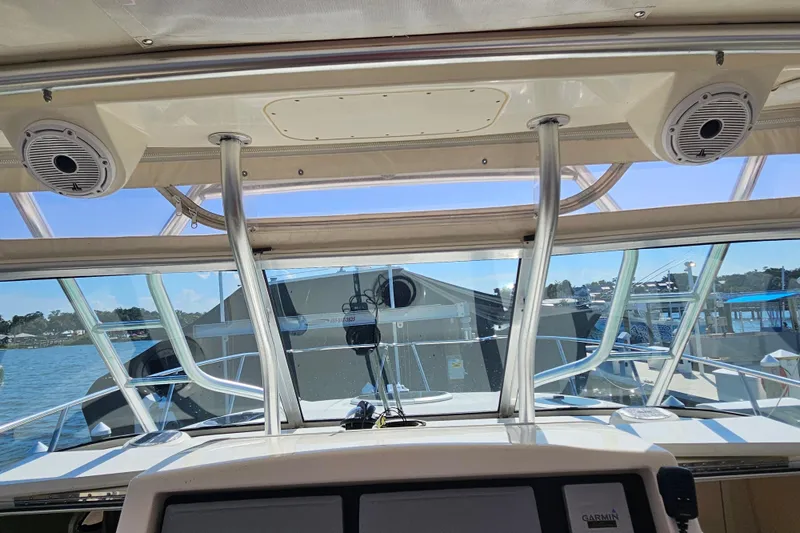 Slide: The Image of Interior view of 2014 World Cat 320 EC boat cockpit with clear windshield. - 5
