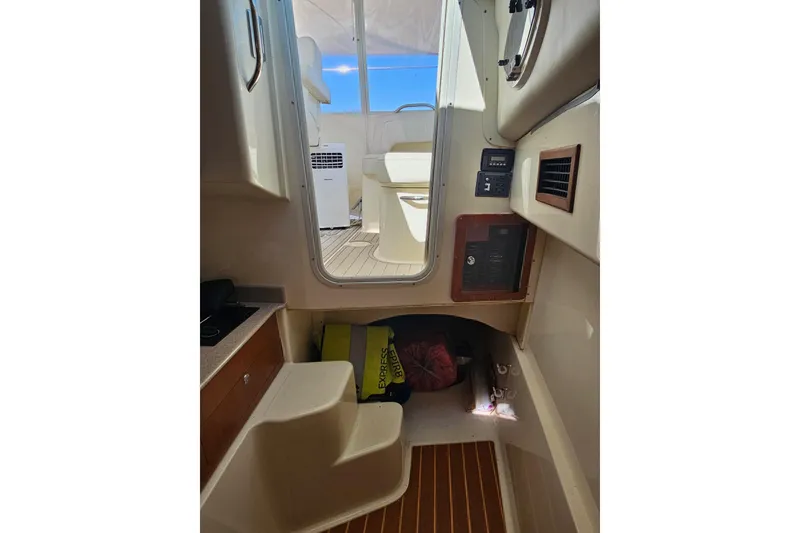 Slide: The Image of Interior view of 2014 World Cat 320 EC boat, featuring steps and cabin area. - 6