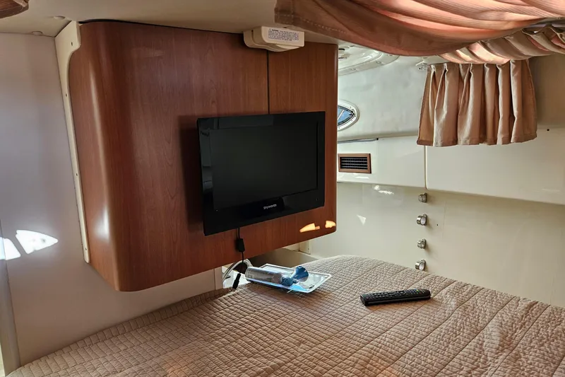 Slide: The Image of Interior of 2014 World Cat 320 EC with TV, bed, and curtains. - 7
