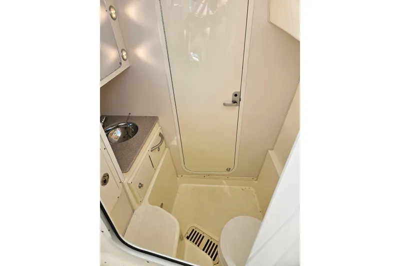 Slide: The Image of 2014 World Cat 320 EC boat interior with sink, cabinet, and door. - 8