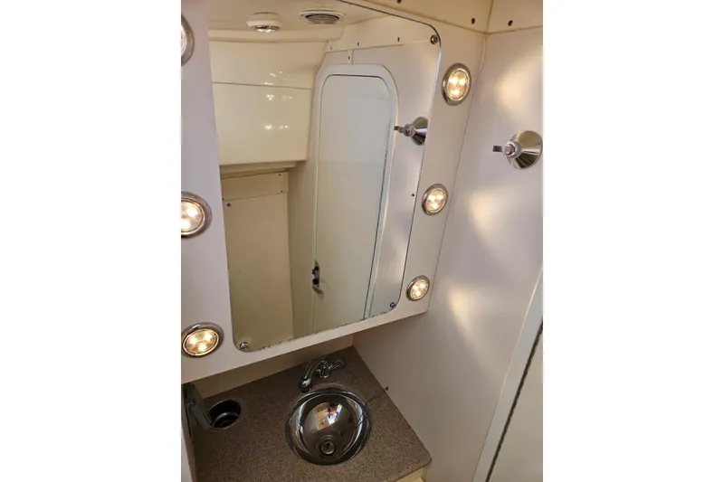 Slide: The Image of 2014 World Cat 320 EC boat bathroom with mirror, lights, and sink. - 9