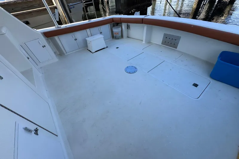 Slide: The Image of Spacious deck of a 1995 Viking 58 Convertible boat, featuring storage compartments and seating. - 11