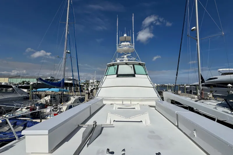 Slide: The Image of 1995 Viking 58 Convertible yacht docked at marina under clear blue sky. - 13