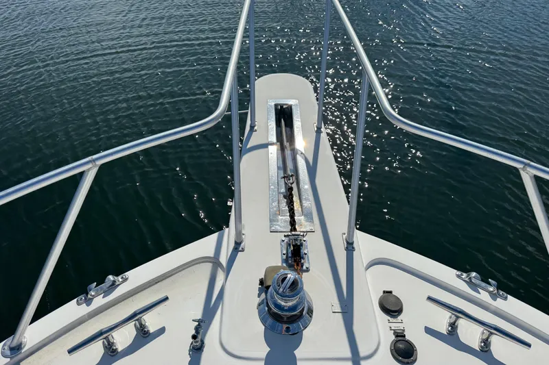 Slide: The Image of Bow of 1995 Viking 58 Convertible yacht with anchor chain over water. - 15