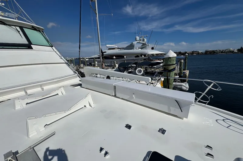 Slide: The Image of 1995 Viking 58 Convertible yacht docked at marina under clear blue sky. - 17