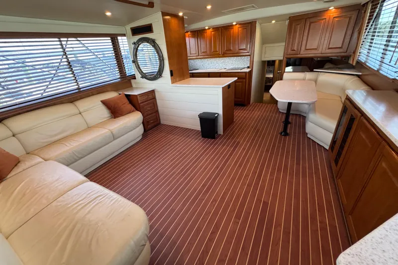 Slide: The Image of Luxurious interior of a 1995 Viking 58 Convertible yacht with elegant wood finishes. - 19