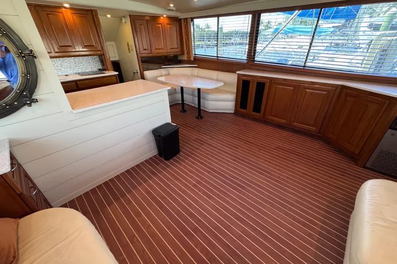 Slide: The Image of Luxurious interior of 1995 Viking 58 Convertible yacht with wood accents and spacious seating. - 20