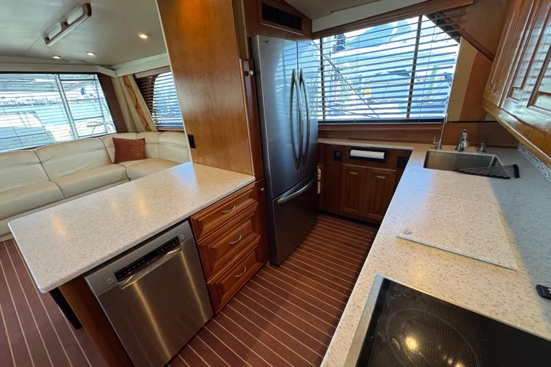 Slide: The Image of Luxurious kitchen interior of a 1995 Viking 58 Convertible yacht with modern appliances. - 24