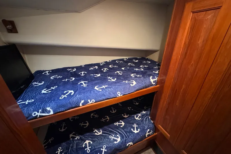 Slide: The Image of Bunk beds with anchor-themed bedding in 1995 Viking 58 Convertible yacht cabin. - 28