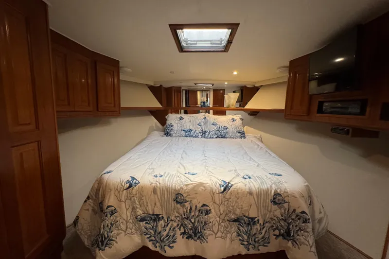 Slide: The Image of Cozy bedroom in 1995 Viking 58 Convertible yacht with nautical-themed bedding. - 29