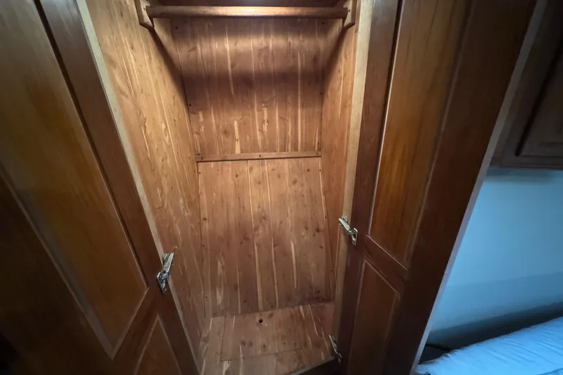 Slide: The Image of Wooden closet interior on a 1995 Viking 58 Convertible boat. - 32
