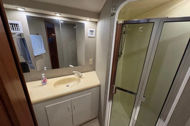 Slide: The Image of Bathroom interior of 1995 Viking 58 Convertible yacht with shower and vanity. - 33