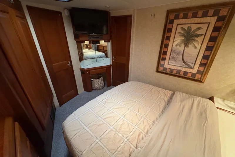 Slide: The Image of Cozy bedroom in 1995 Viking 58 Convertible yacht with palm tree artwork. - 37