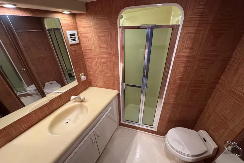 Slide: The Image of Bathroom interior of 1995 Viking 58 Convertible yacht with shower, sink, and toilet. - 38