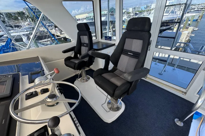 Slide: The Image of Interior of 1995 Viking 58 Convertible yacht with helm and two captain chairs. - 42