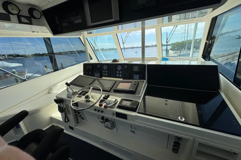 Slide: The Image of Cockpit of 1995 Viking 58 Convertible yacht with navigation instruments and scenic water view. - 43