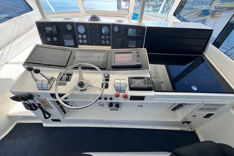Slide: The Image of Cockpit of 1995 Viking 58 Convertible yacht with steering wheel and navigation instruments. - 44