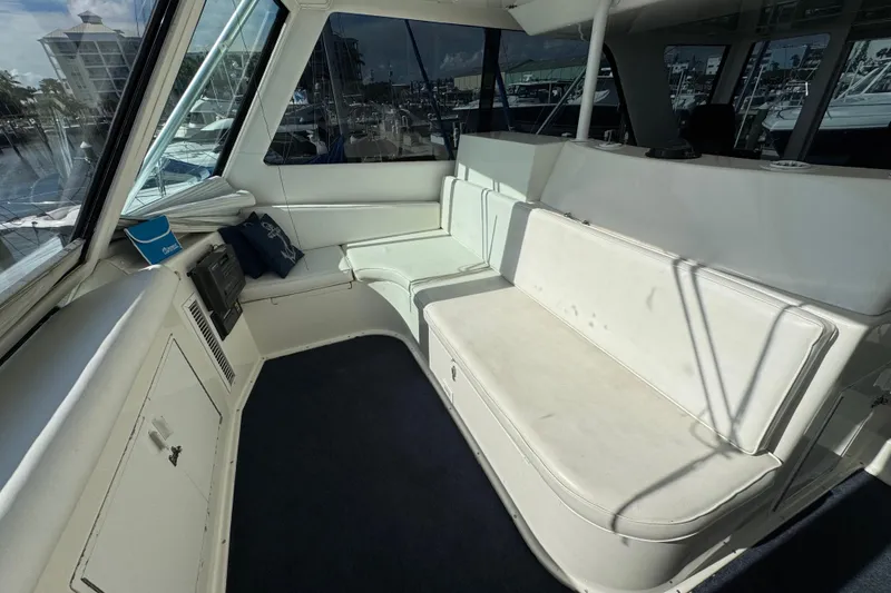 Slide: The Image of Interior of 1995 Viking 58 Convertible yacht with white seating and windows. - 45