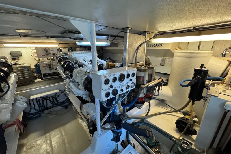 Slide: The Image of Engine room of a 1995 Viking 58 Convertible yacht, showcasing machinery and control panels. - 48