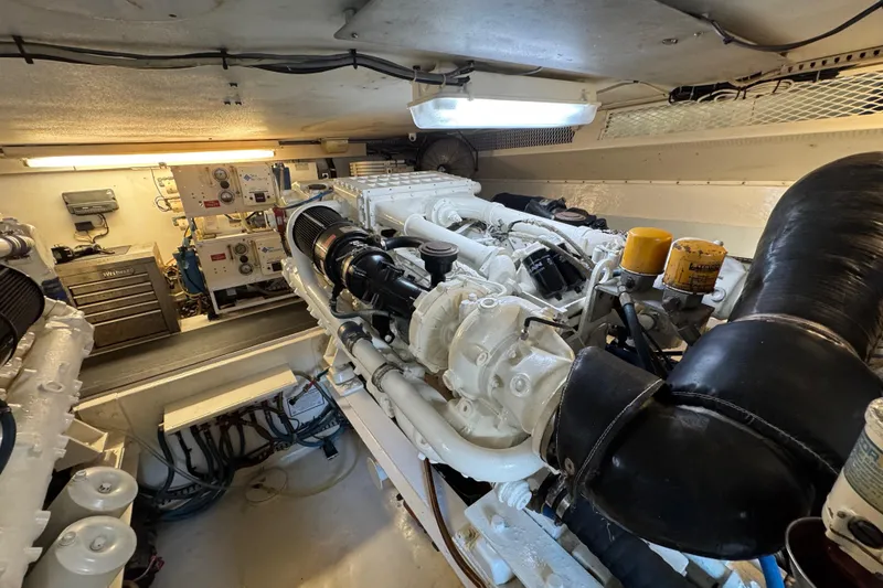 Slide: The Image of Engine room of a 1995 Viking 58 Convertible yacht, showcasing machinery and equipment. - 49