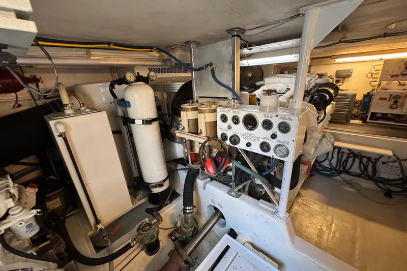 Slide: The Image of Engine room of a 1995 Viking 58 Convertible yacht, showcasing machinery and control panels. - 50