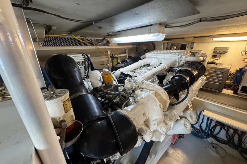 Slide: The Image of Engine room of a 1995 Viking 58 Convertible yacht, showcasing detailed machinery. - 51