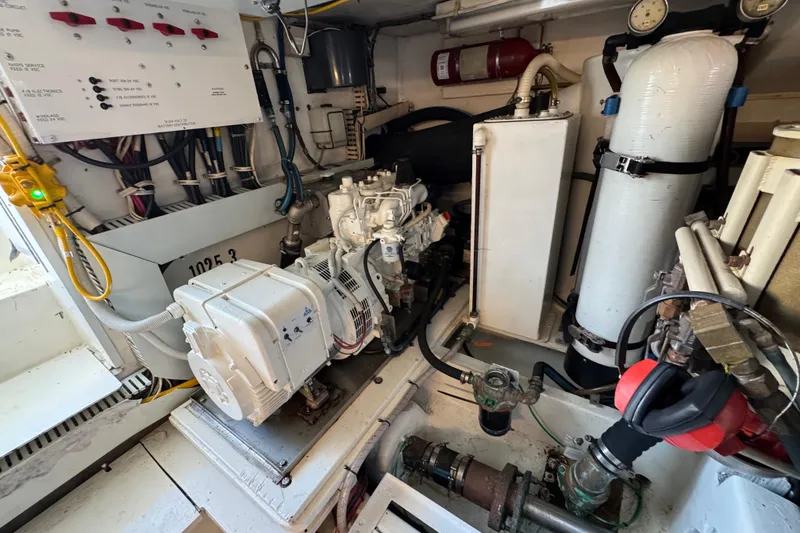 Slide: The Image of Engine room of a 1995 Viking 58 Convertible yacht, showcasing mechanical components and wiring. - 52