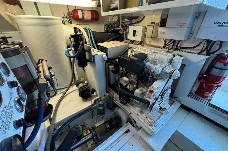 Slide: The Image of Engine room of 1995 Viking 58 Convertible yacht with visible machinery and fire extinguisher. - 53