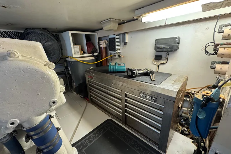 Slide: The Image of Engine room of a 1995 Viking 58 Convertible with tools and equipment. - 55