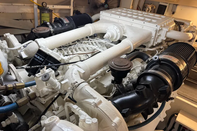 Slide: The Image of Engine room of a 1995 Viking 58 Convertible yacht, showcasing detailed machinery components. - 57