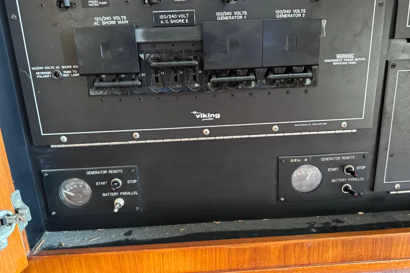 Slide: The Image of Electrical panel of a 1995 Viking 58 Convertible boat with generator controls. - 59