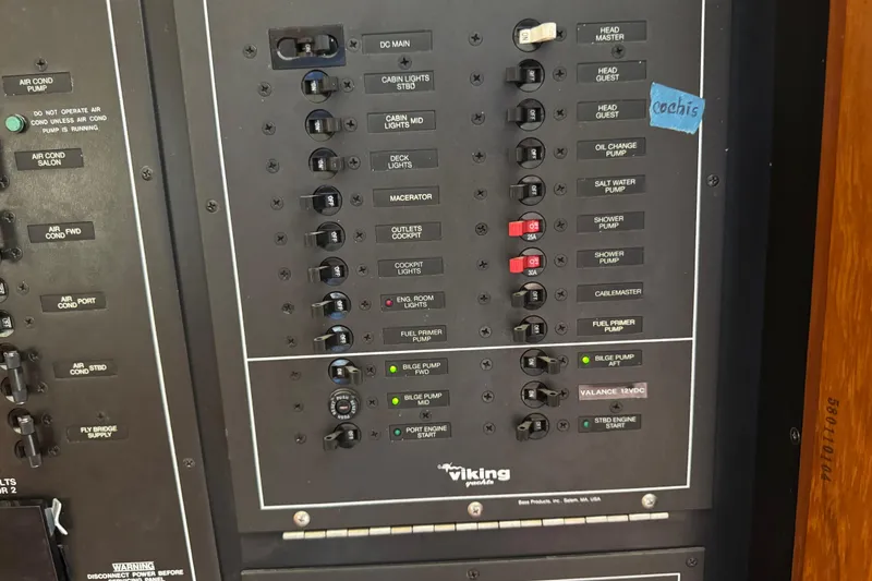 Slide: The Image of Control panel of a 1995 Viking 58 Convertible yacht with various switches and labels. - 60