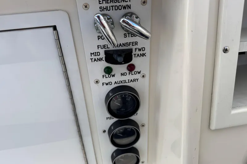 Slide: The Image of Control panel of a 1995 Viking 58 Convertible boat, featuring fuel transfer and emergency shutdown. - 63