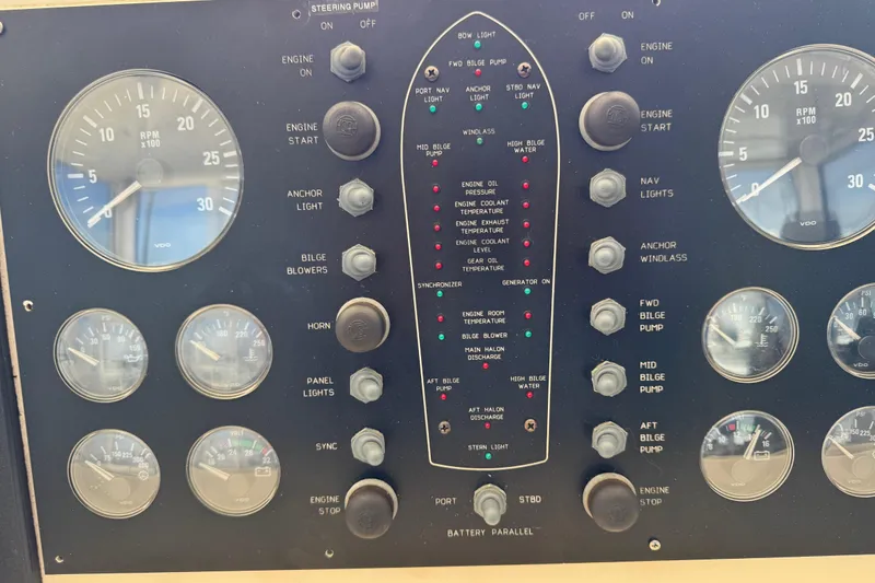 Slide: The Image of Control panel of a 1995 Viking 58 Convertible boat with gauges and switches. - 64