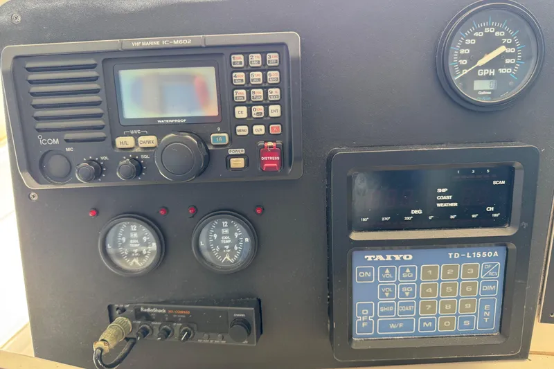 Slide: The Image of Control panel of a 1995 Viking 58 Convertible boat with various gauges and equipment. - 65