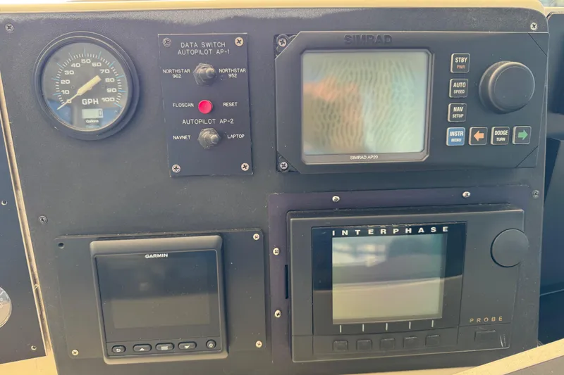 Slide: The Image of Control panel of a 1995 Viking 58 Convertible boat with navigation instruments. - 66