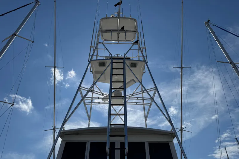 Slide: The Image of 1995 Viking 58 Convertible yacht tower against a clear blue sky. - 7