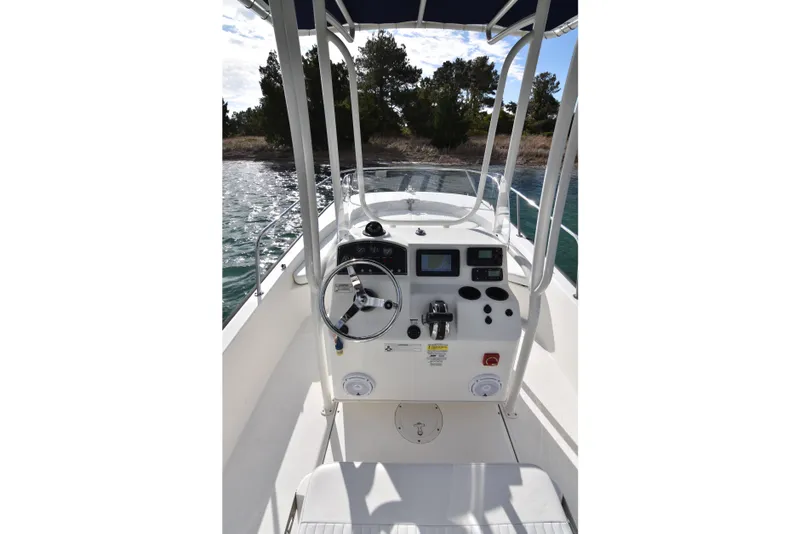 Slide: The Image of 2015 Boston Whaler 190 Montauk boat console with steering wheel and navigation controls. - 10