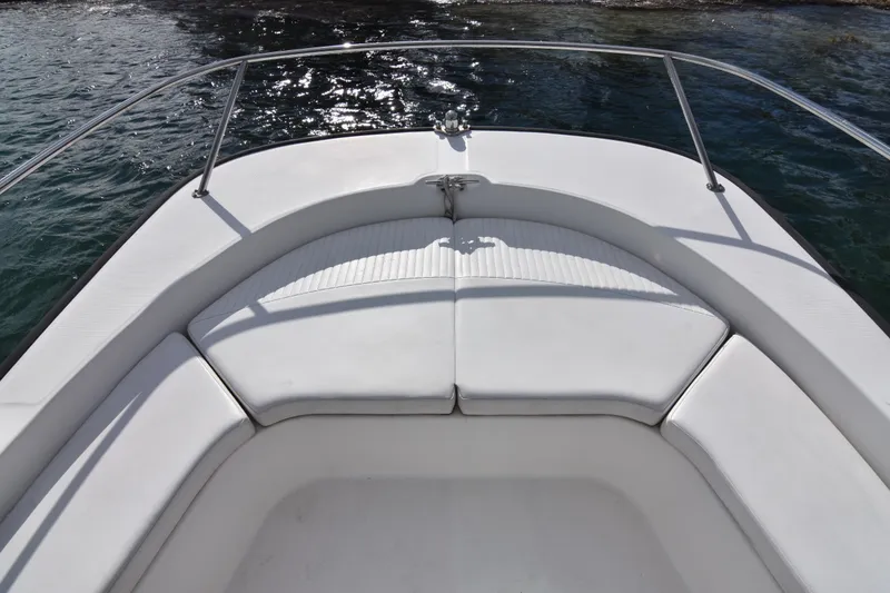 Slide: The Image of Bow seating area of a 2015 Boston Whaler 190 Montauk boat on water. - 12