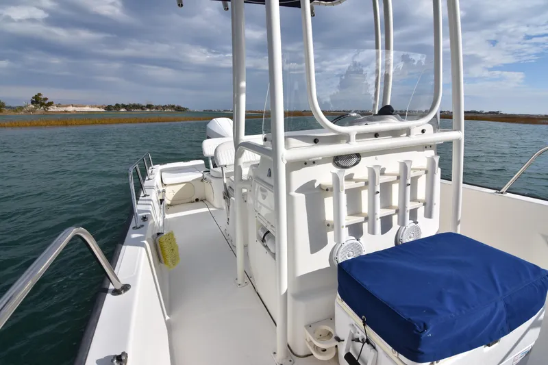 Slide: The Image of 2015 Boston Whaler 190 Montauk boat on water, featuring center console and seating. - 14