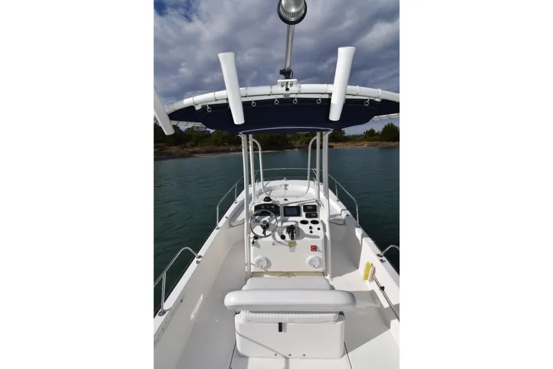 Slide: The Image of 2015 Boston Whaler 190 Montauk boat interior with steering console and canopy. - 16