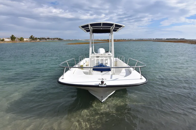 Slide: The Image of 2015 Boston Whaler 190 Montauk boat on clear water under cloudy sky. - 2