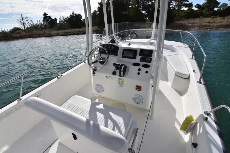 Slide: The Image of 2015 Boston Whaler 190 Montauk boat interior with steering console and seating. - 7
