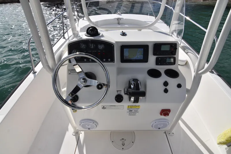 Slide: The Image of 2015 Boston Whaler 190 Montauk boat console with steering wheel and navigation controls. - 9