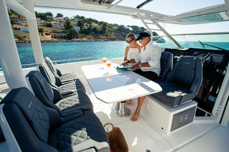 Slide: The Image of 2025 Axopar 37 Sun Top BRABUS Trim yacht with passengers enjoying a sunny day. - 6