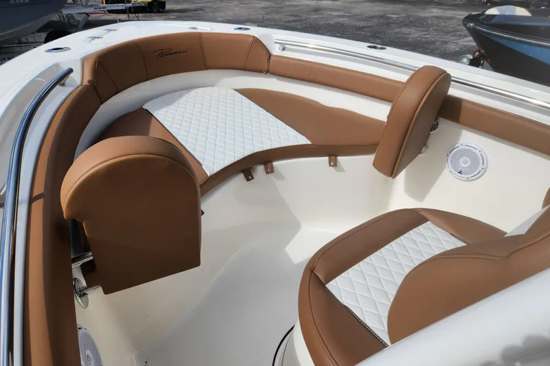 Slide: The Image of 2026 Pioneer 202 Islander boat interior with brown and white cushioned seating. - 10
