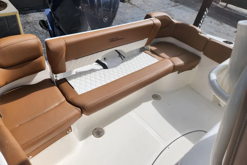 Slide: The Image of 2026 Pioneer 202 Islander boat interior with brown leather seating and white accents. - 2