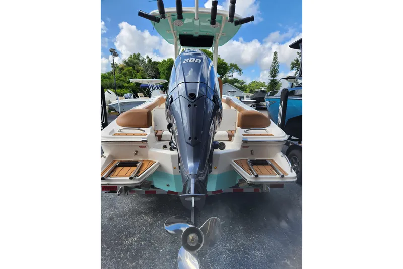 Slide: The Image of 2026 Pioneer 202 Islander boat with powerful outboard motor, docked outdoors. - 3