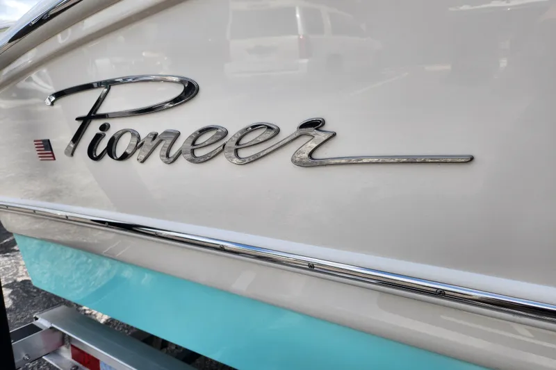 Slide: The Image of 2026 Pioneer 202 Islander boat with sleek logo and American flag detail. - 7