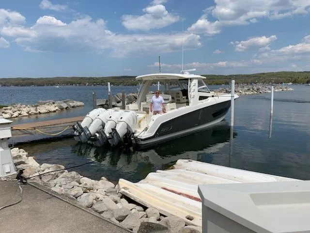 Slide: The Image of 2019 Boston Whaler 420 Outrage boat docked with four Mercury engines. - 3